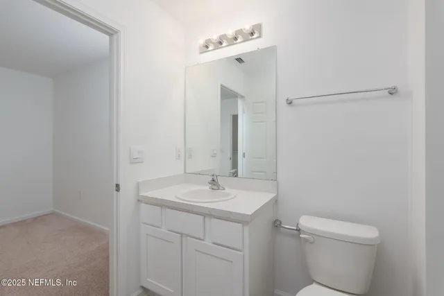 a bathroom with a bathtub shower sink vanity and toilet