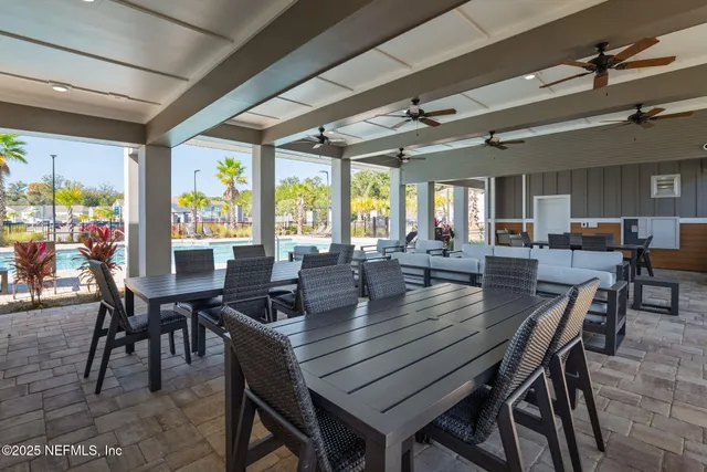 a view of swimming pool with chair and wooden fence