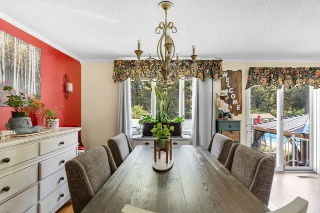 a dining room with furniture a livingroom and chandelier