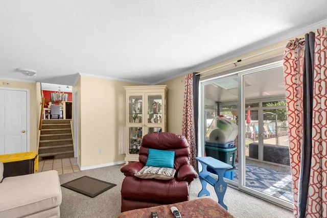 a living room with furniture and a floor to ceiling window