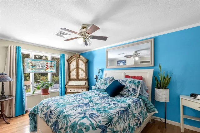 a bed sitting in a bedroom next to a window