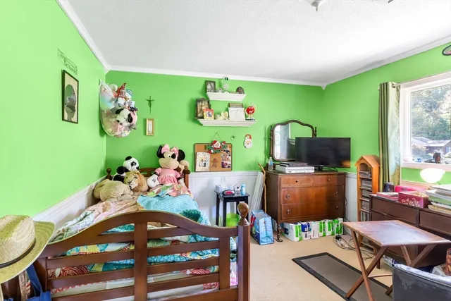 a bedroom with furniture a baby crib and a wooden floor