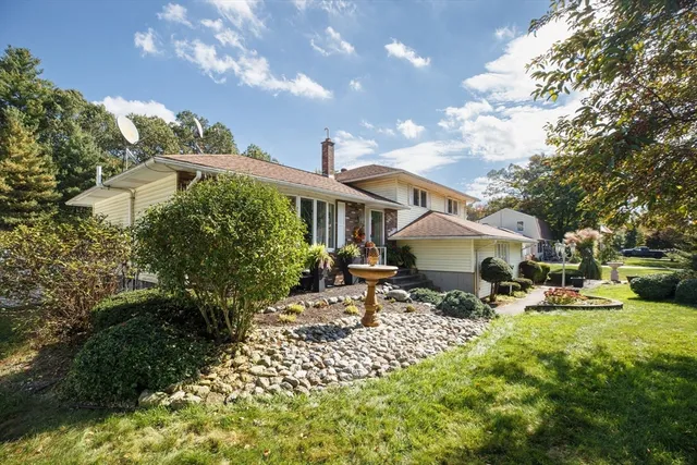 a backyard of a house with table and chairs
