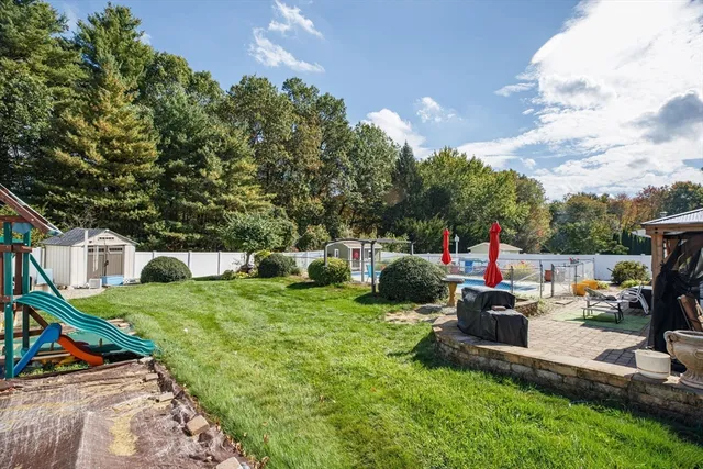 a view of a house with backyard sitting area and slide