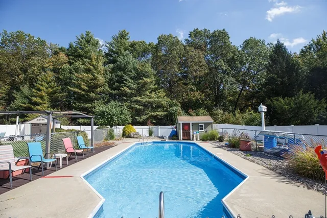 swimming pool view with a seating space