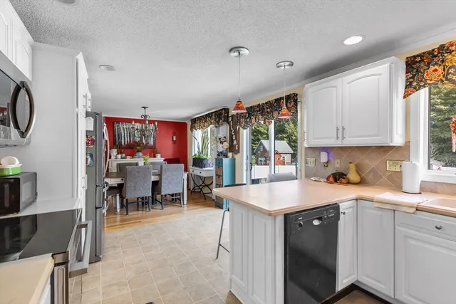 a kitchen that has a lot of cabinets a sink and a stove in it