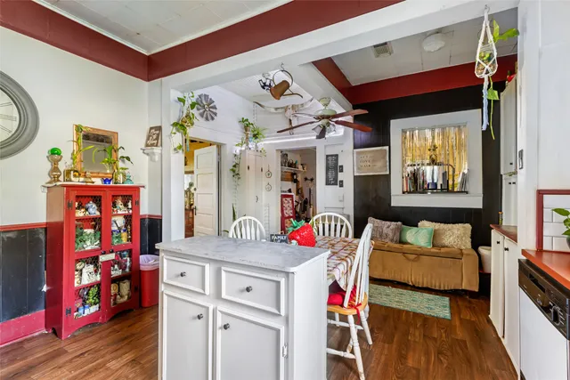a dining room with stainless steel appliances kitchen island granite countertop a table and chairs in it