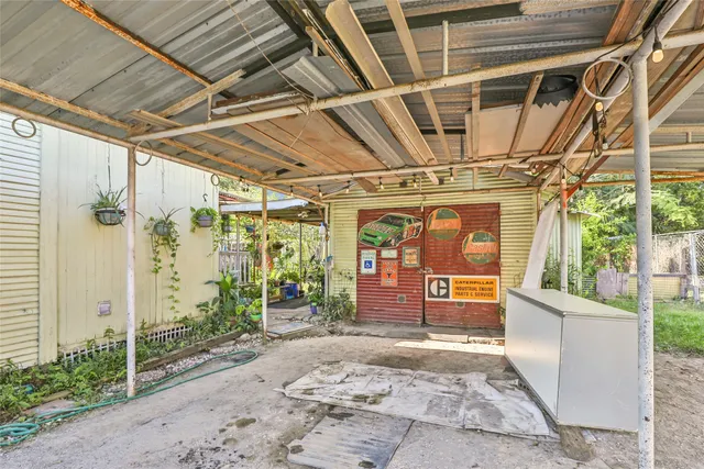 a view of a garage with a large tree