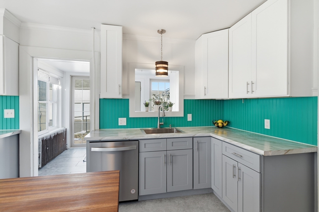 1201 Allen Street Springfield, MA 01118 - Photo 11 of 42 a kitchen with a sink cabinets and window