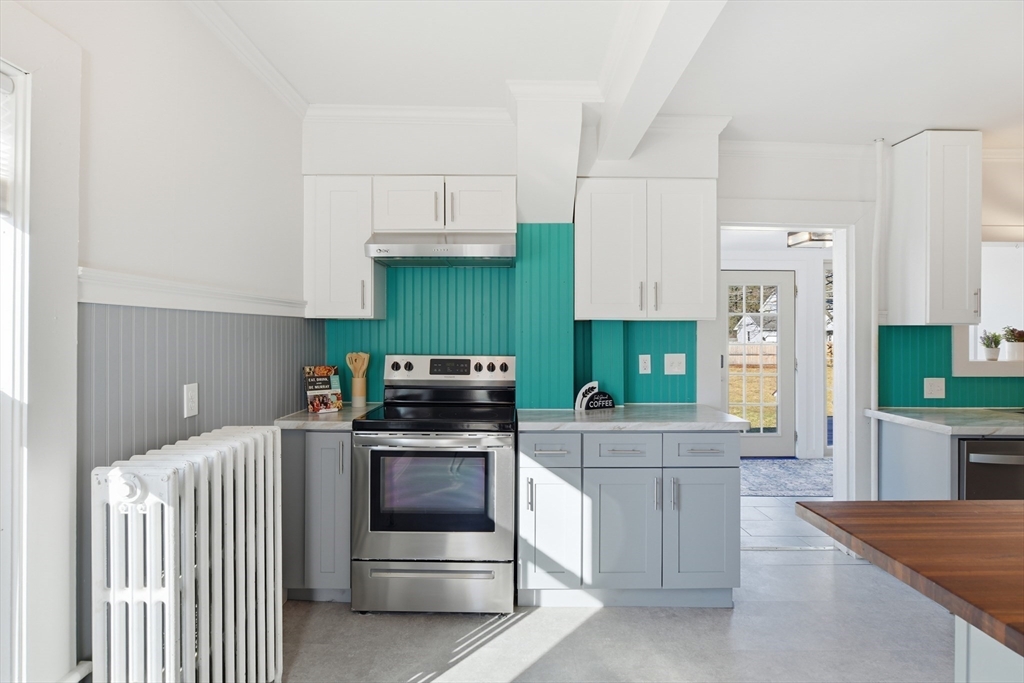 1201 Allen Street Springfield, MA 01118 - Photo 12 of 42 a kitchen with stainless steel appliances a stove a sink and a refrigerator