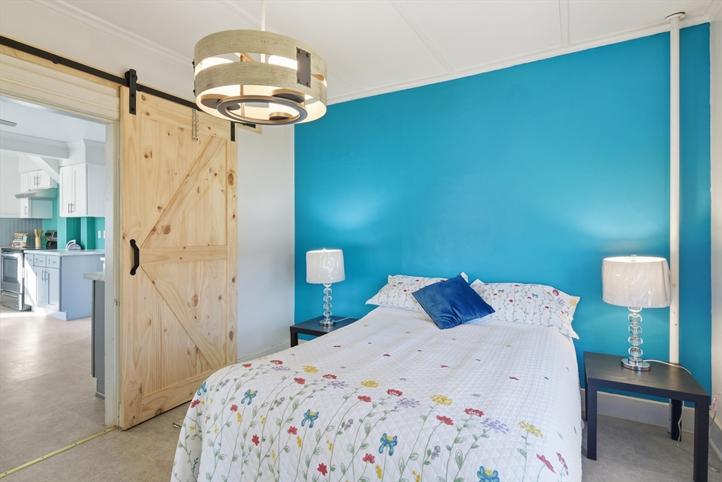 1201 Allen Street Springfield, MA 01118 - Photo 20 of 42 a bedroom with a bed and a chandelier