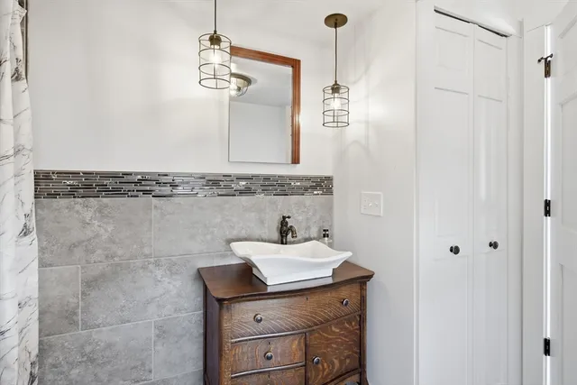 a bathroom with a sink a mirror and shower