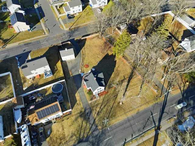 a bird view of a house with a yard