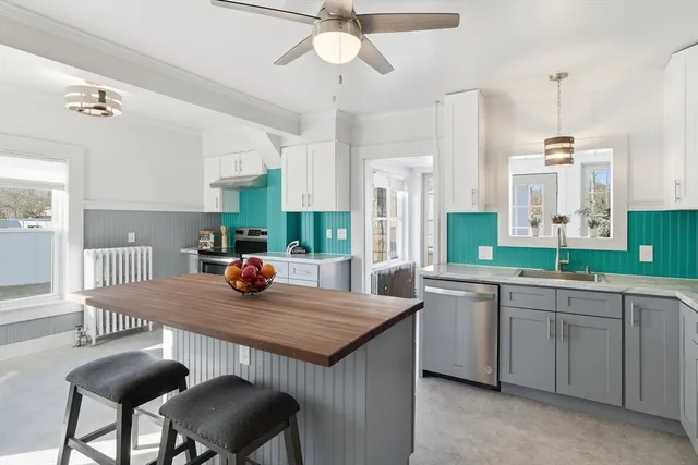 a kitchen with a dining table chairs sink and stove