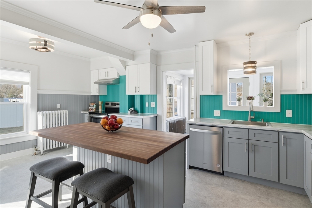 1201 Allen Street Springfield, MA 01118 - Photo 10 of 42 a kitchen with a dining table chairs sink and stove
