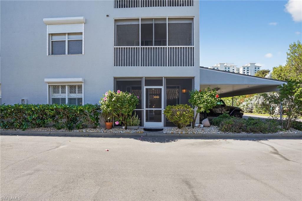 519 Roma Court, Unit 3101 Naples, FL 34110 - Photo 1 of 30 front view of a house with a yard