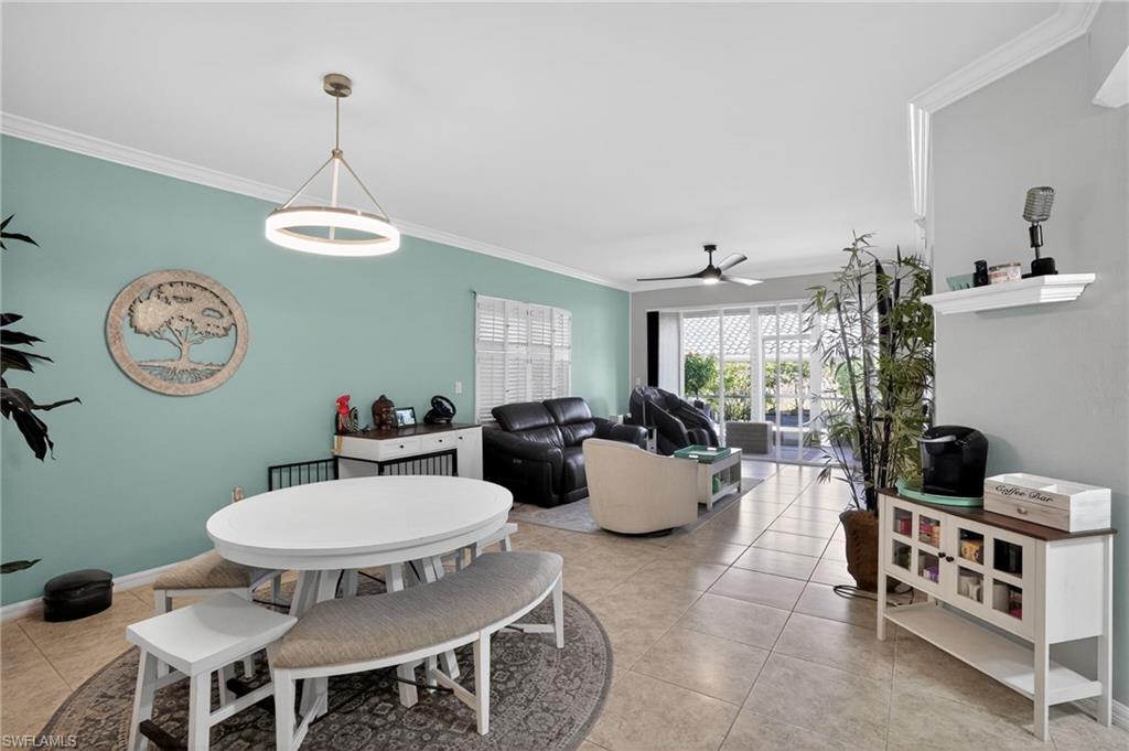 519 Roma Court, Unit 3101 Naples, FL 34110 - Photo 14 of 30 a view of a dining room with furniture and a chandelier