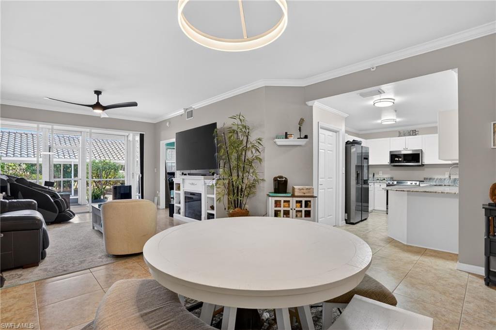 519 Roma Court, Unit 3101 Naples, FL 34110 - Photo 15 of 30 a view of kitchen with dining table and chairs