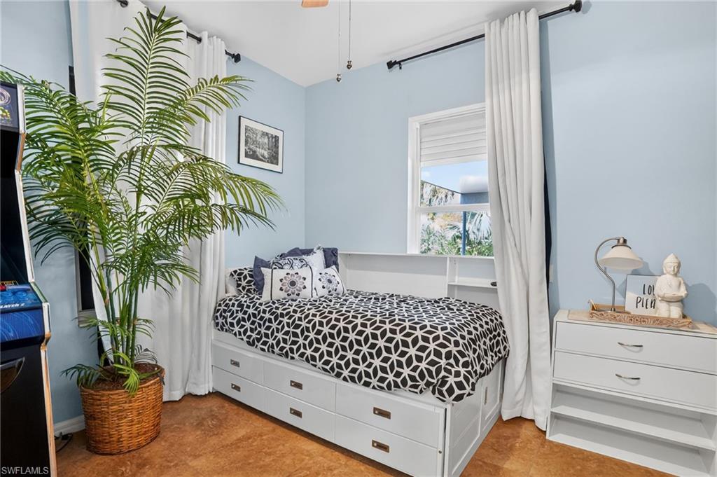 519 Roma Court, Unit 3101 Naples, FL 34110 - Photo 20 of 30 a bedroom with a bed and a potted plant