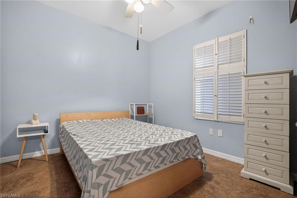 519 Roma Court, Unit 3101 Naples, FL 34110 - Photo 22 of 30 a bedroom with a bed and a dresser