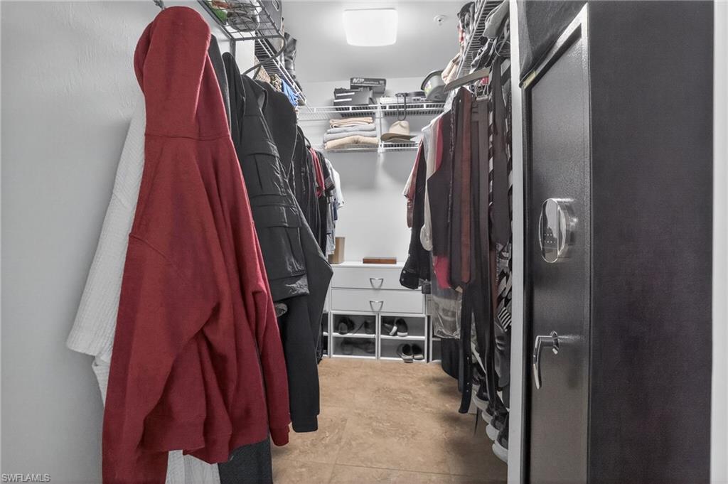 519 Roma Court, Unit 3101 Naples, FL 34110 - Photo 23 of 30 a view of walk in closet with clothes and shoes