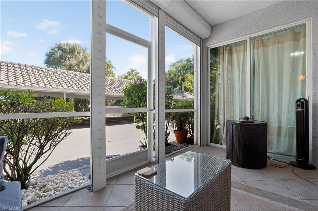 519 Roma Court, Unit 3101 Naples, FL 34110 - Photo 27 of 30 a balcony with table and chairs