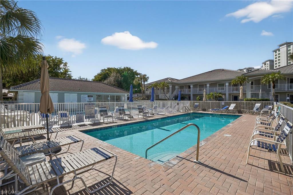 519 Roma Court, Unit 3101 Naples, FL 34110 - Photo 29 of 30 a view of swimming pool with outdoor seating and a potted plants
