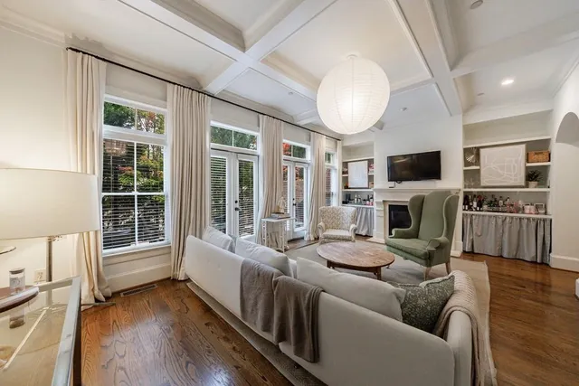 a view of a patio with couches table and chairs and potted plants