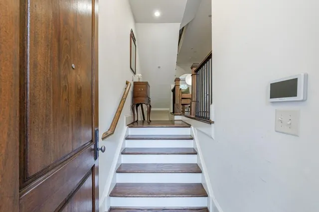 a view of entryway livingroom and hall with wooden floor