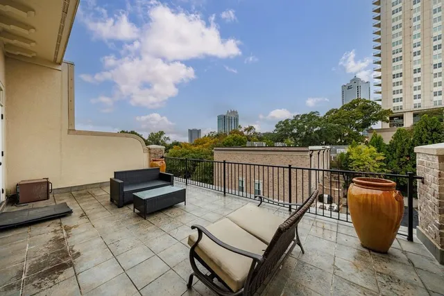 a bedroom with a bed a chandelier and closet