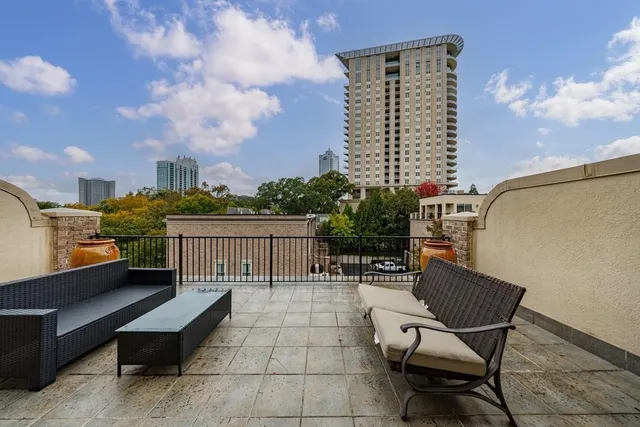 a living room with furniture a chandelier and a dining table