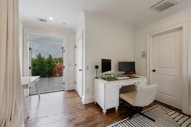 a view of a couches and table in the patio and a garden