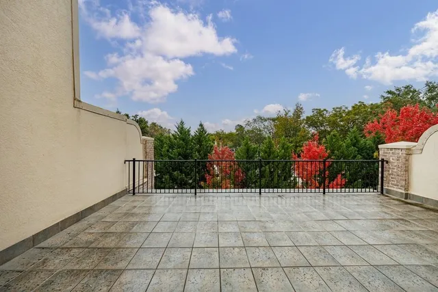 a view of backyard with table and chairs and floor to ceiling window