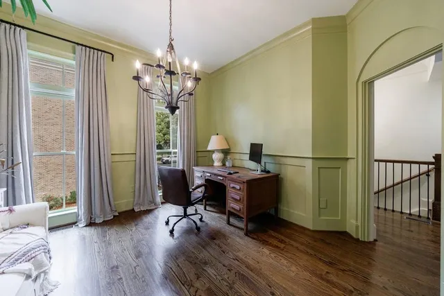 a kitchen with stainless steel appliances granite countertop a stove a sink dishwasher a refrigerator and a dining table with wooden floor