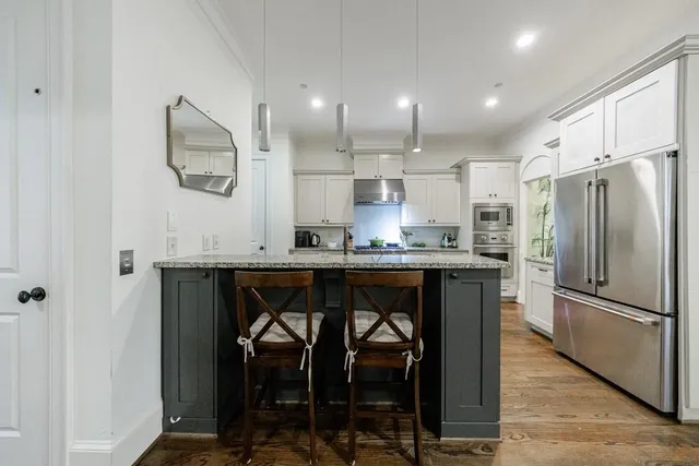a kitchen with stainless steel appliances granite countertop a stove and cabinets