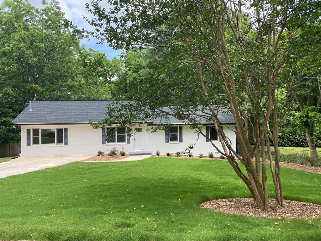 a front view of house with yard and green space