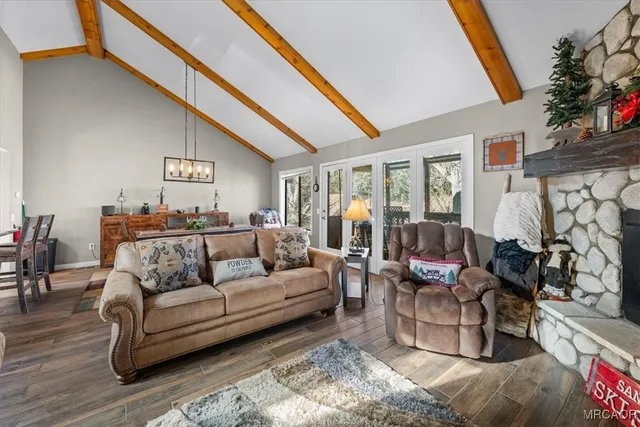 a view of a dining room with furniture large windows and wooden floor