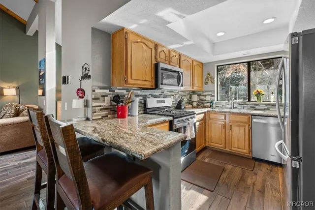 a kitchen with stainless steel appliances granite countertop a stove sink and microwave