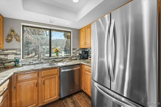 a kitchen with stainless steel appliances granite countertop a stove and a microwave