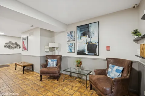 a living room with furniture and painting on the wall
