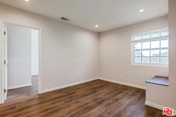 wooden floor in a hall with an empty room