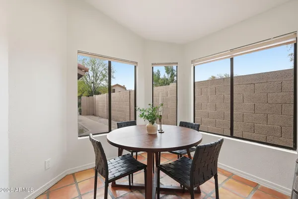 a dining room with furniture and window