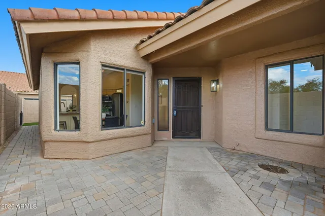 a view of a house with a large window and yard