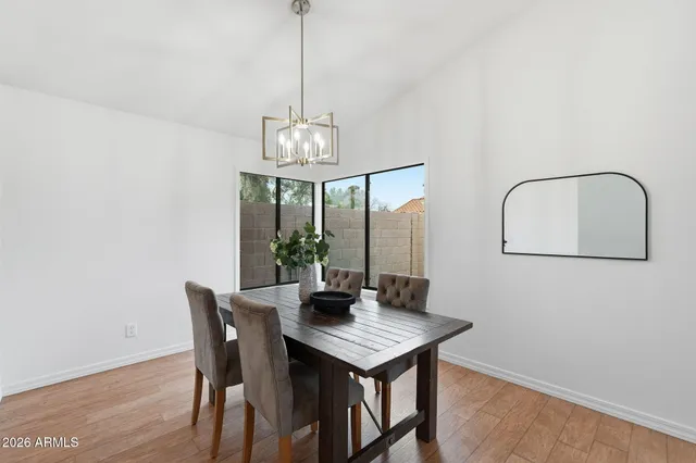 a view of a dining room with a table and chairs