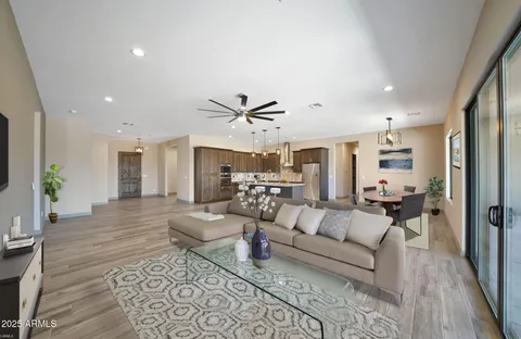 a living room with furniture and a chandelier