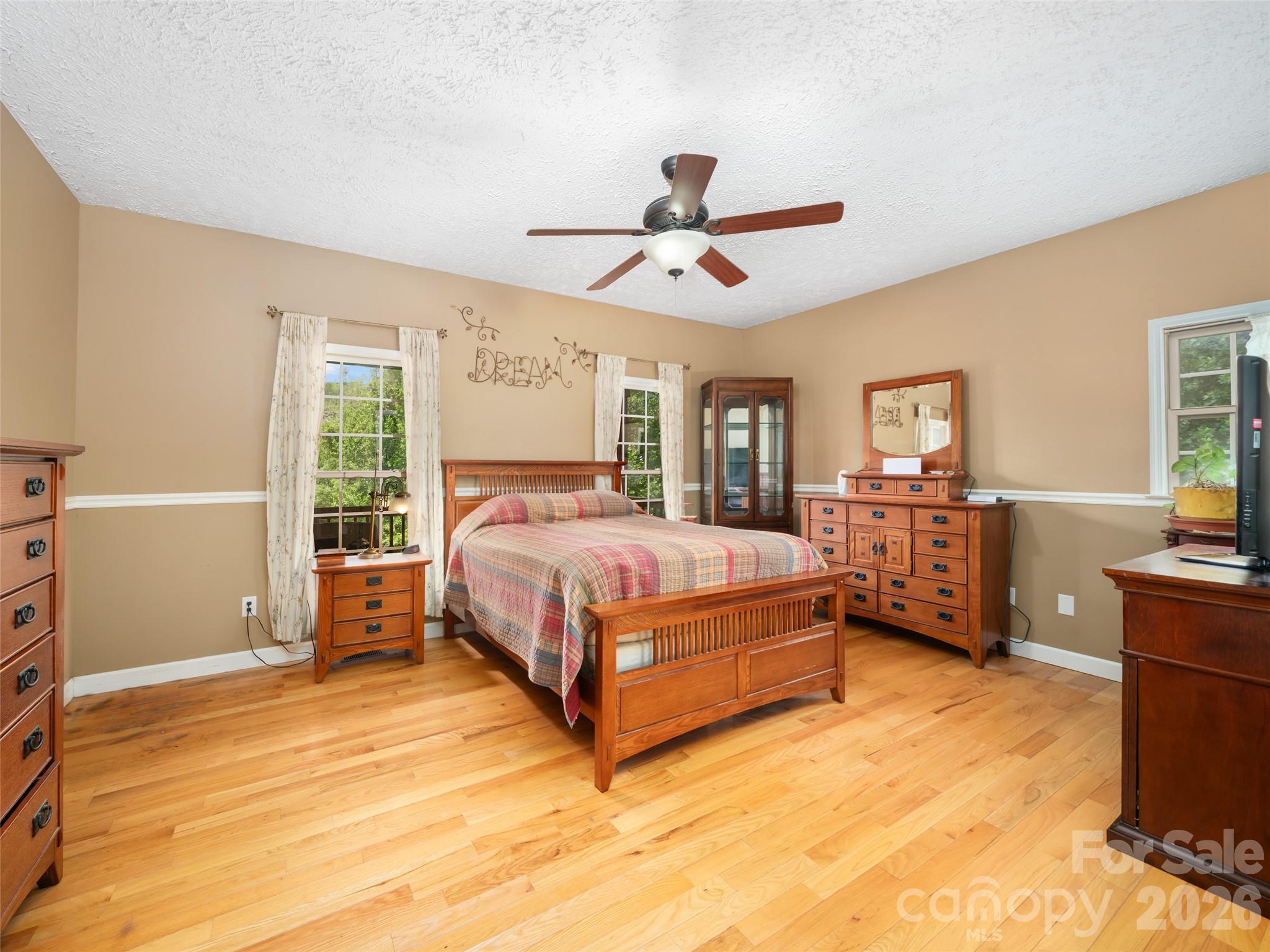 2216 Beans Creek Road Bakersville, NC 28705 - Photo 13 of 39 a bedroom with a bed and wooden floor