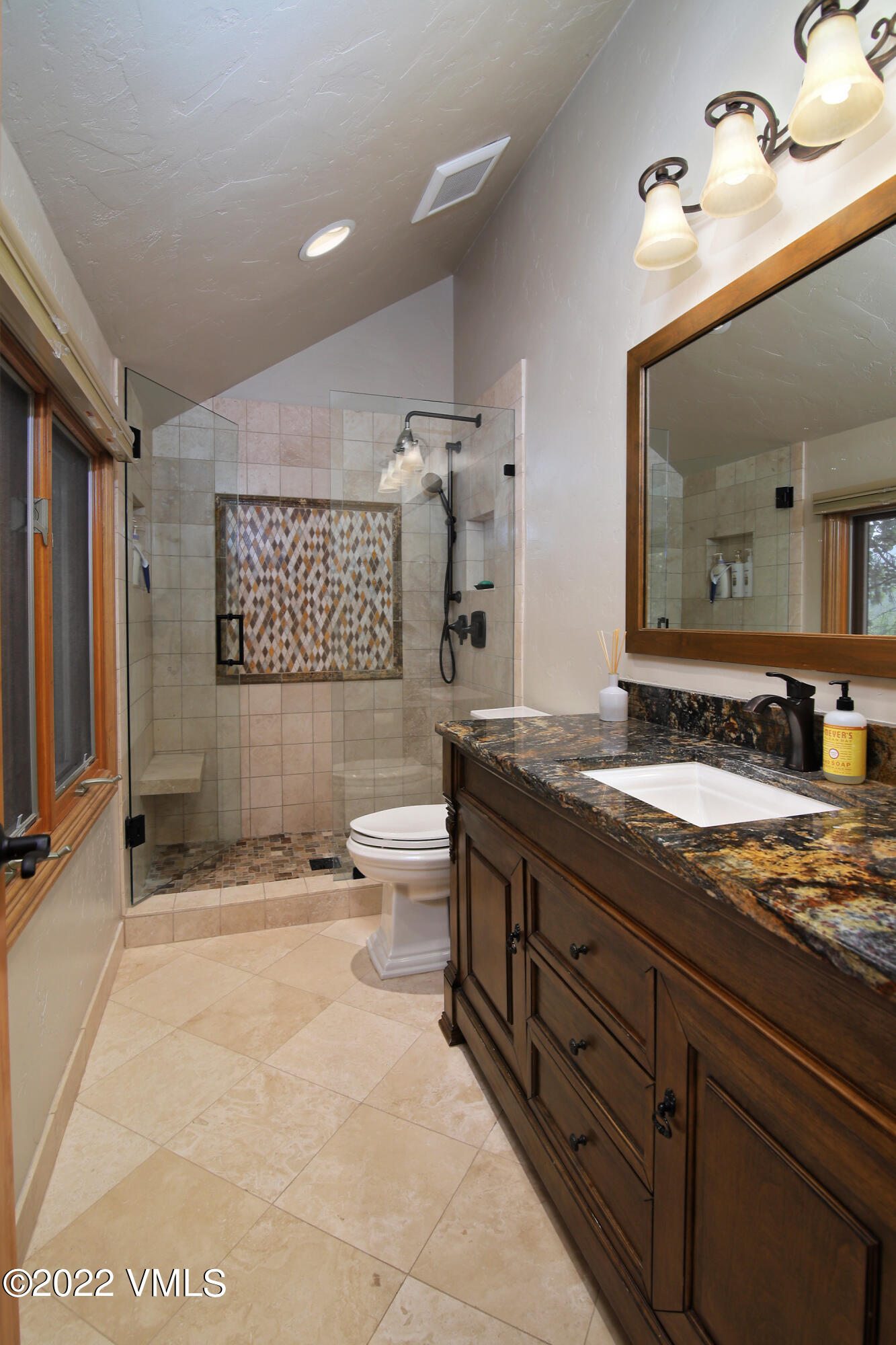 2875 Manns Ranch Road, Unit H3 Vail, CO 81657 - Photo 13 of 18 a spacious bathroom with a granite countertop sink a toilet and mirror