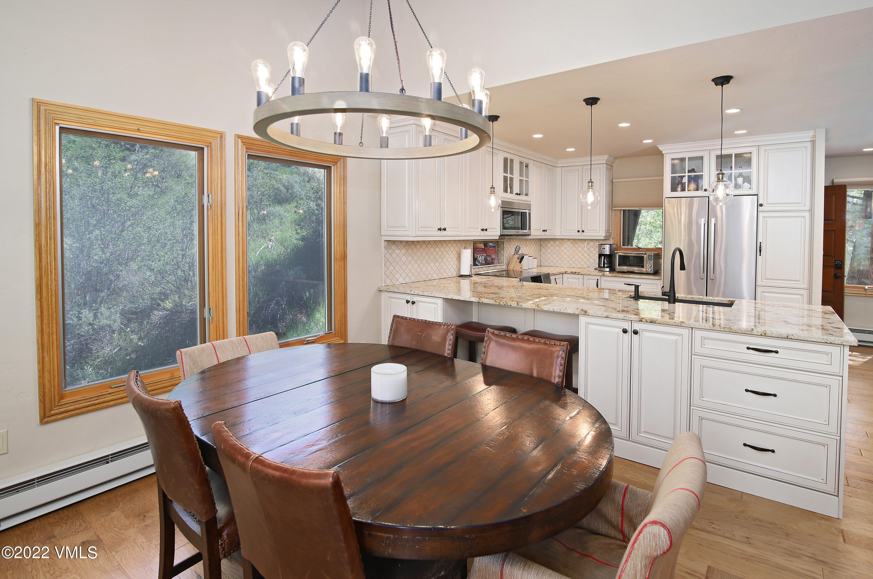 2875 Manns Ranch Road, Unit H3 Vail, CO 81657 - Photo 5 of 18 a kitchen with stainless steel appliances a dining table chairs and wooden floor