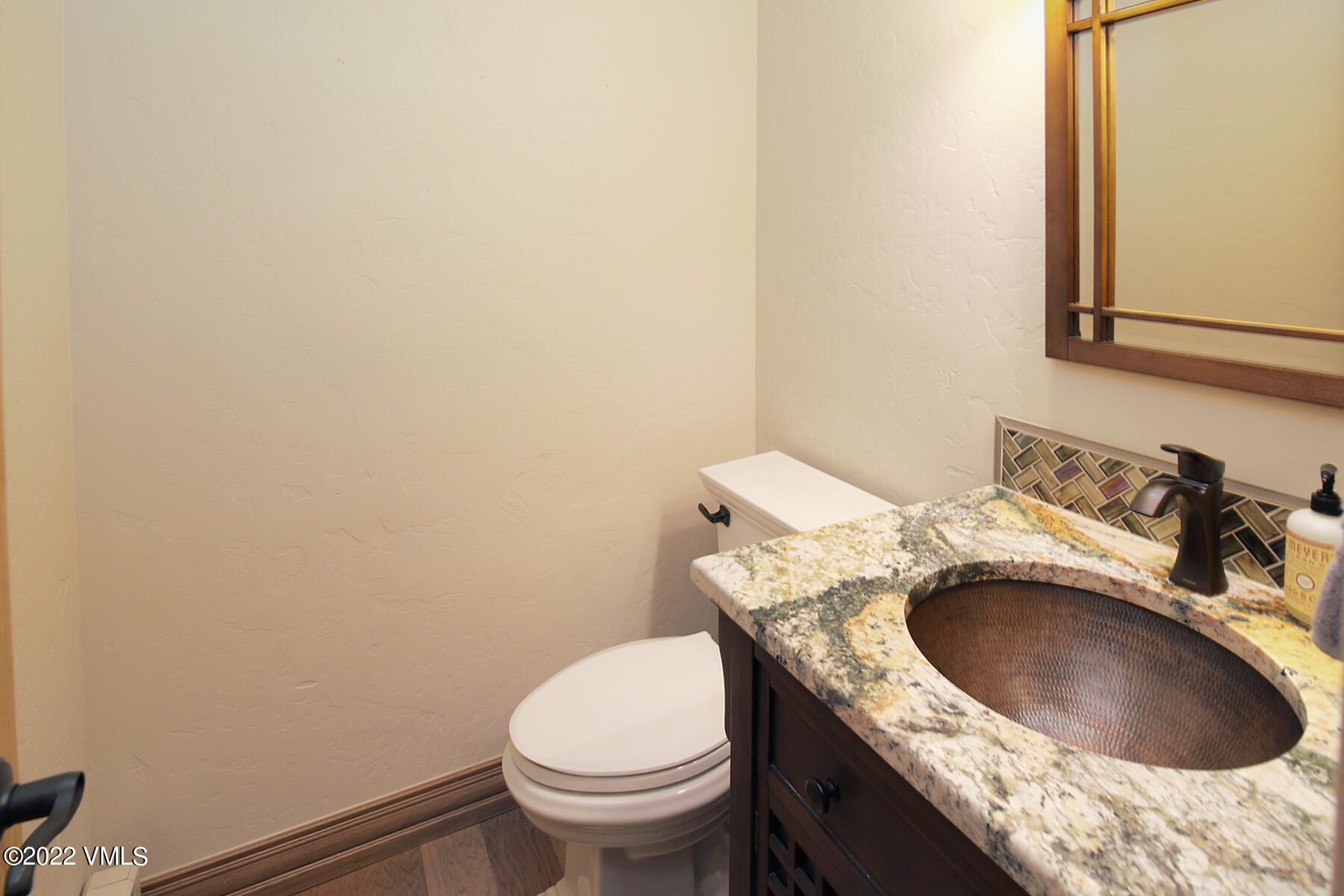 2875 Manns Ranch Road, Unit H3 Vail, CO 81657 - Photo 10 of 18 a bathroom with a granite countertop toilet sink and mirror