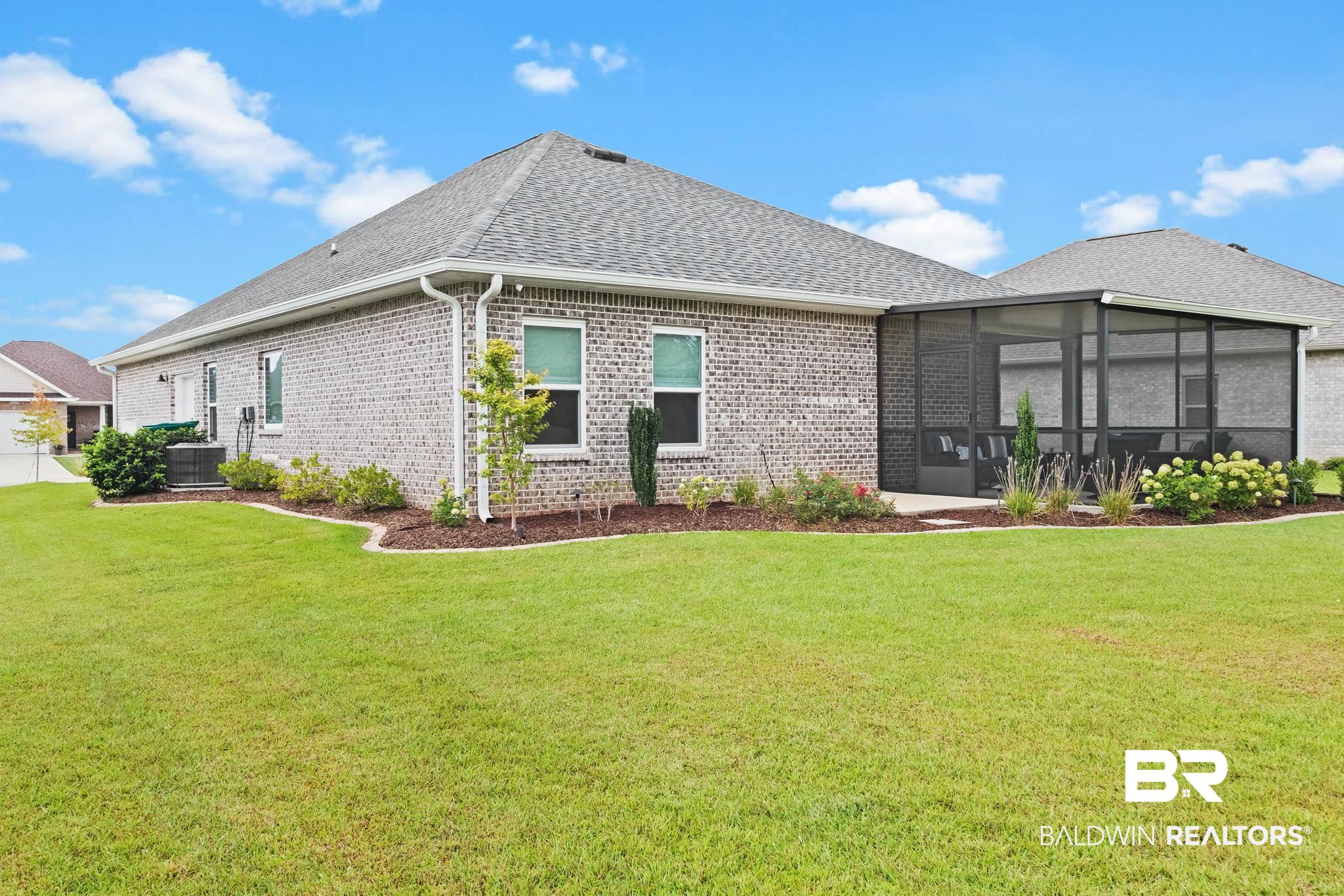 9815 Lakeview Drive Foley, AL 36535 - Photo 70 of 100 Back of property featuring central AC, a lawn, and a sunroom
